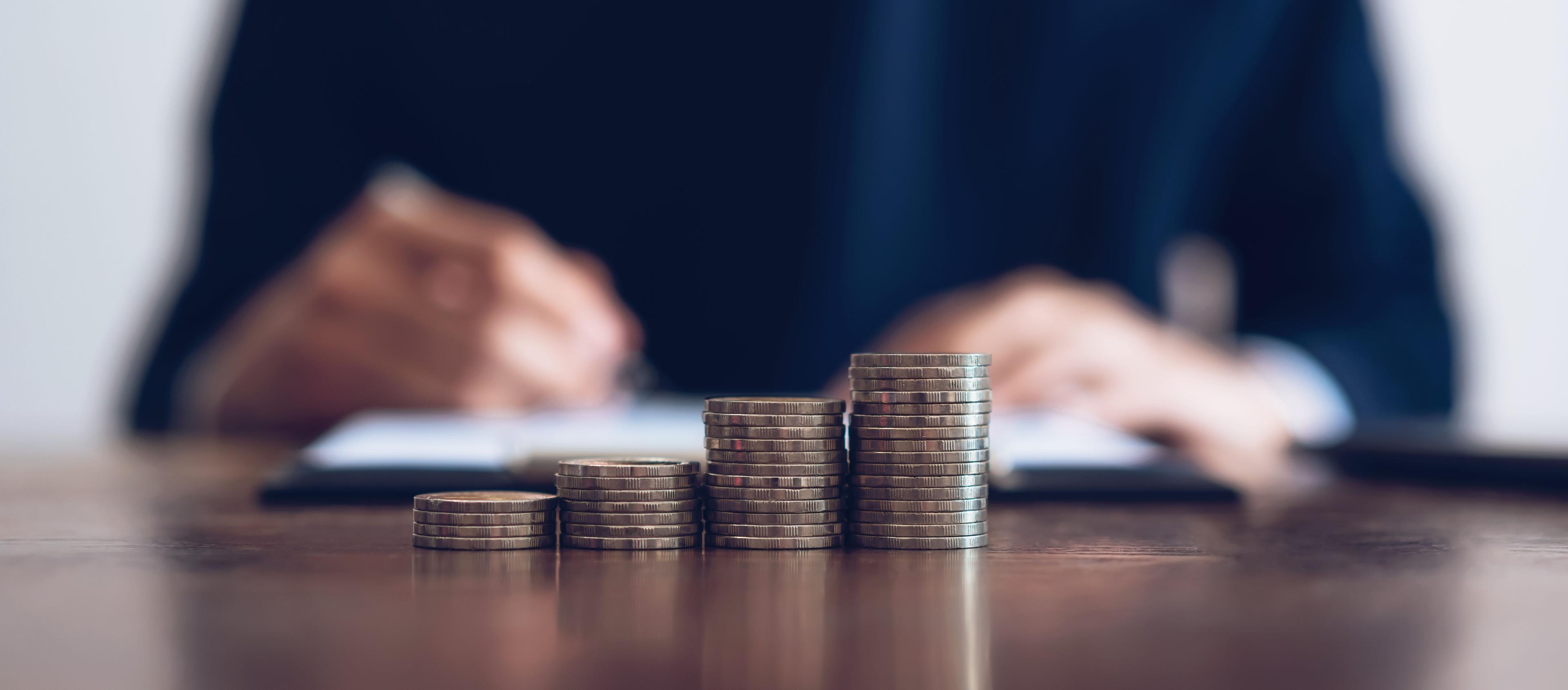 Growing stacks of coins symbolizing capital growth