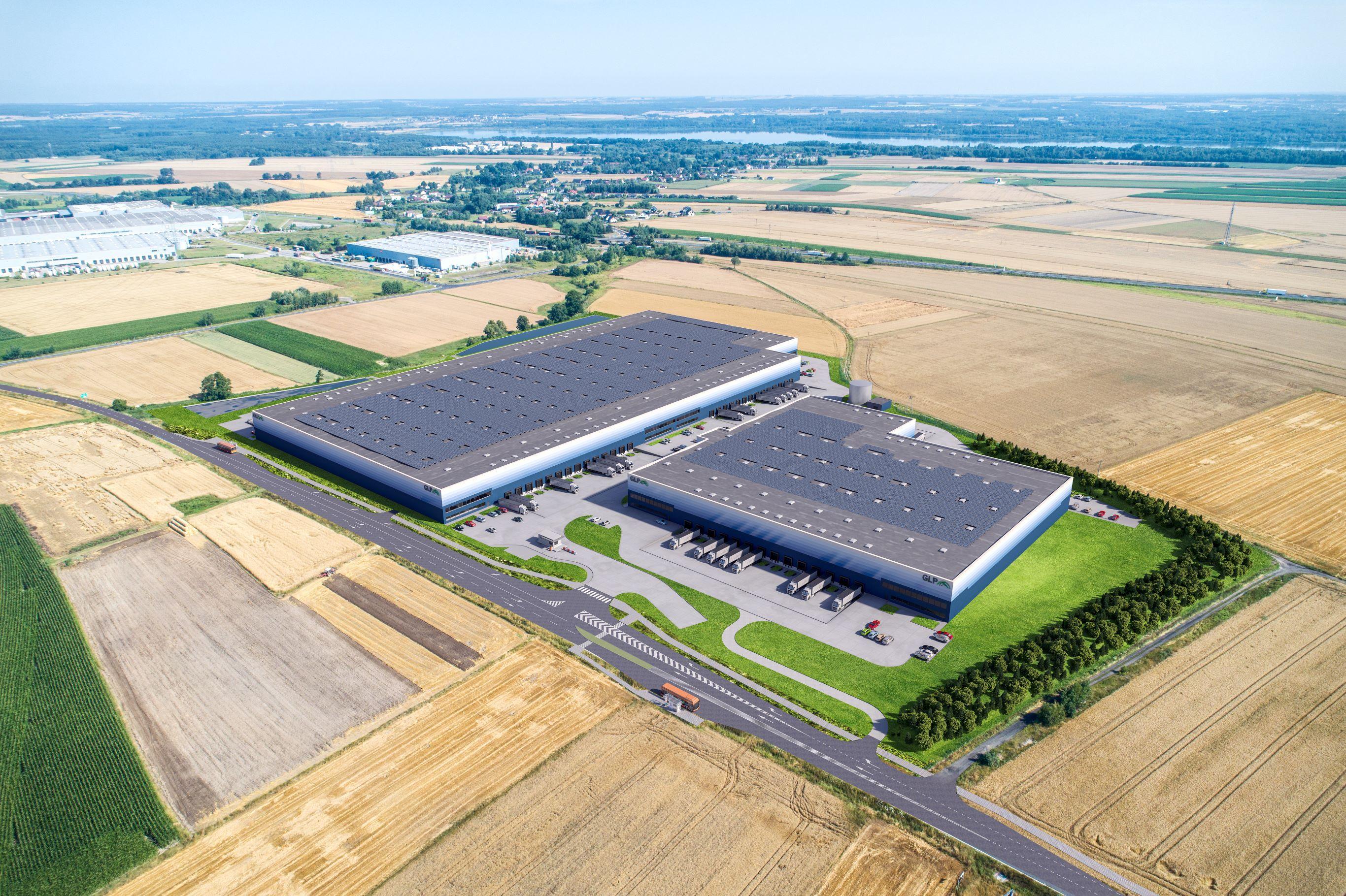 Aerial view of the Greenyard warehouse at Marq Logistics Centre in Gliwice, showing a modern logistics complex with two warehouse buildings, loading docks, truck yards, and surrounding farmland.